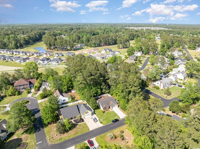 birds eye view of property with a water view, a residential view, and a forest view