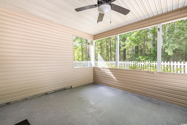 unfurnished sunroom with ceiling fan