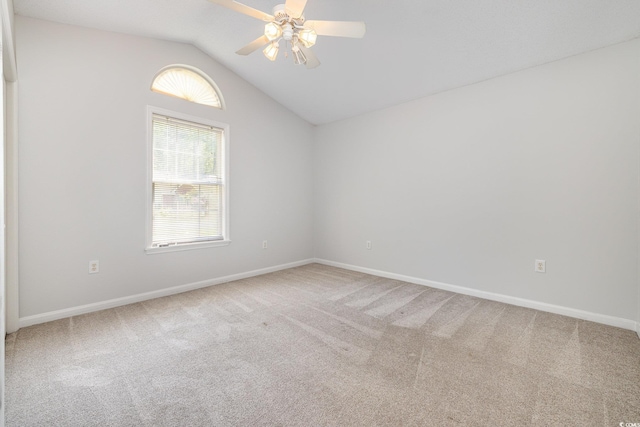 unfurnished room featuring carpet floors, ceiling fan, baseboards, and lofted ceiling