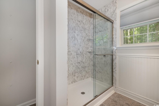 full bathroom with tile patterned flooring and a shower stall