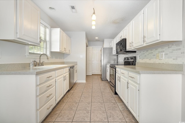 kitchen with white cabinets, stainless steel appliances, and a sink