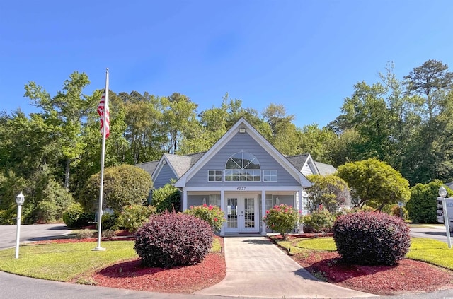 view of community featuring a lawn and driveway