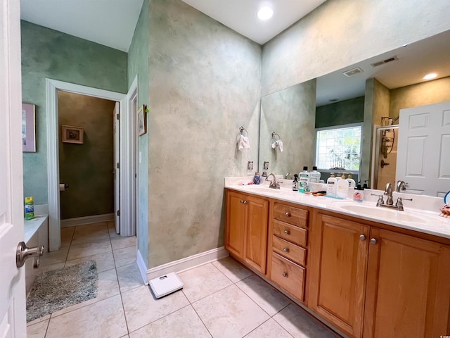 bathroom with double vanity, visible vents, and a sink