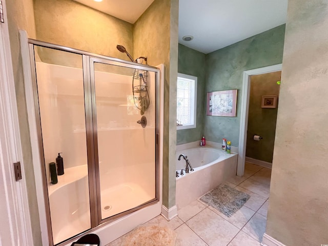 full bath featuring tile patterned flooring, a stall shower, and a bath