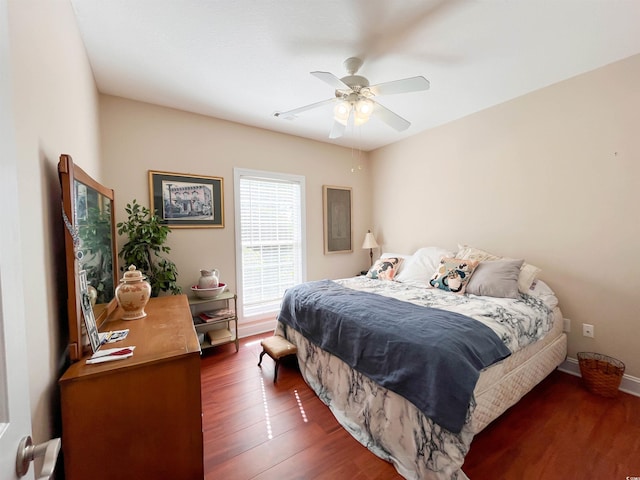 bedroom featuring baseboards, ceiling fan, and wood finished floors