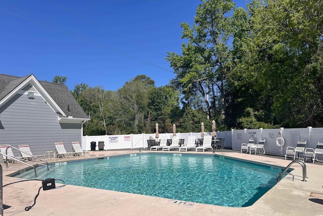 pool with fence and a patio area