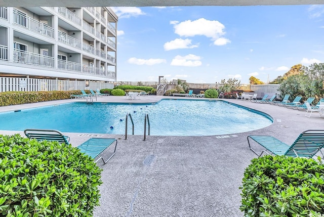 1581 S Waccamaw Dr Unit 302, Garden City Beach, SC 29576 - pool featuring a patio area and fence