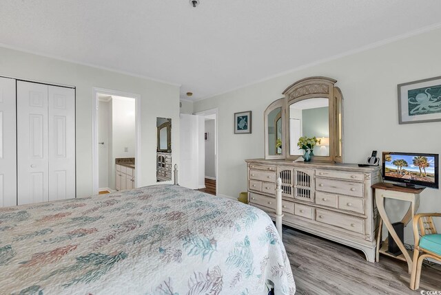 1581 S Waccamaw Dr Unit 302, Garden City Beach, SC 29576 - bedroom with crown molding, baseboards, a closet, and wood finished floors