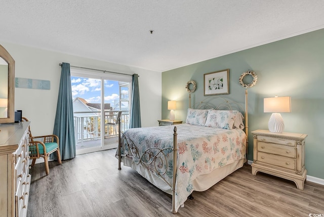 1581 S Waccamaw Dr Unit 302, Garden City Beach, SC 29576 - bedroom with a textured ceiling, access to exterior, wood finished floors, and ornamental molding