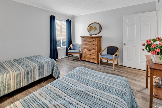 1581 S Waccamaw Dr Unit 302, Garden City Beach, SC 29576 - bedroom with a textured ceiling and wood finished floors