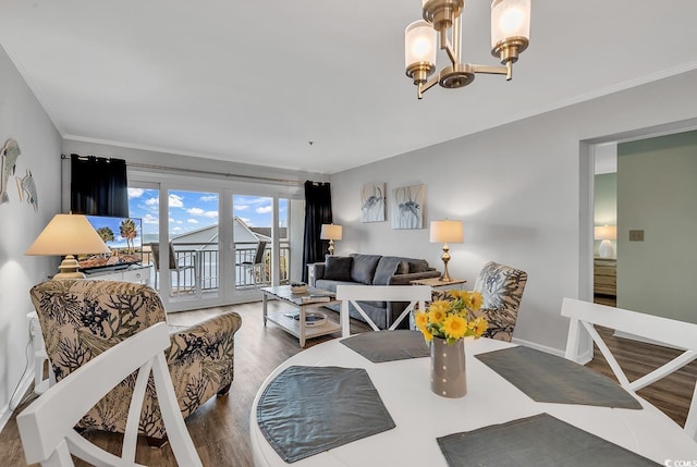 1581 S Waccamaw Dr Unit 302, Garden City Beach, SC 29576 - living area featuring french doors, crown molding, wood finished floors, and a notable chandelier