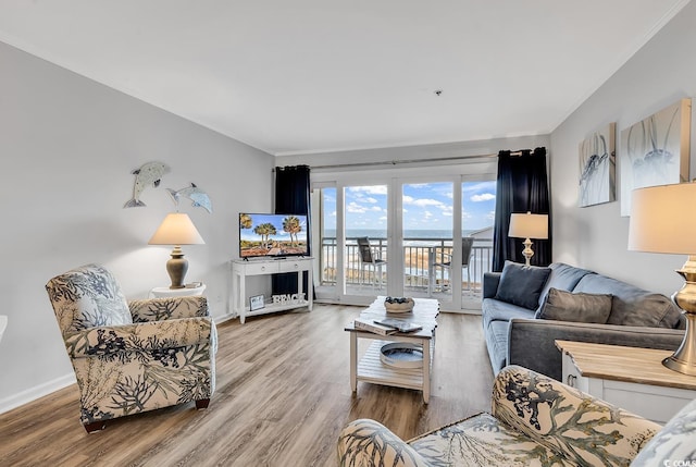 1581 S Waccamaw Dr Unit 302, Garden City Beach, SC 29576 - living room with baseboards, crown molding, and wood finished floors