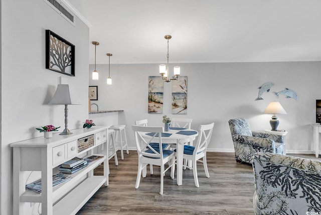 1581 S Waccamaw Dr Unit 302, Garden City Beach, SC 29576 - dining room with an inviting chandelier, ornamental molding, wood finished floors, and visible vents