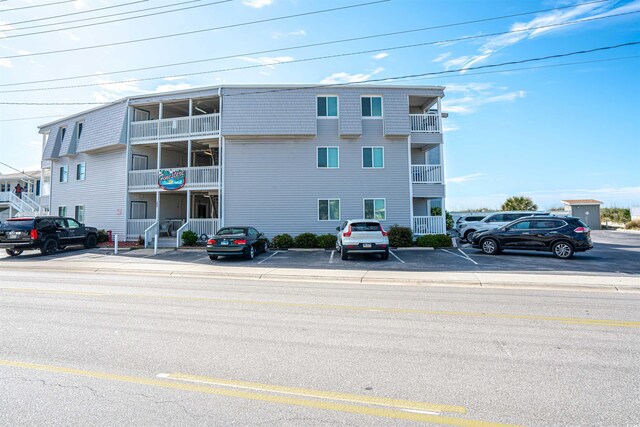view of building exterior with uncovered parking