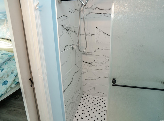 bathroom with a marble finish shower