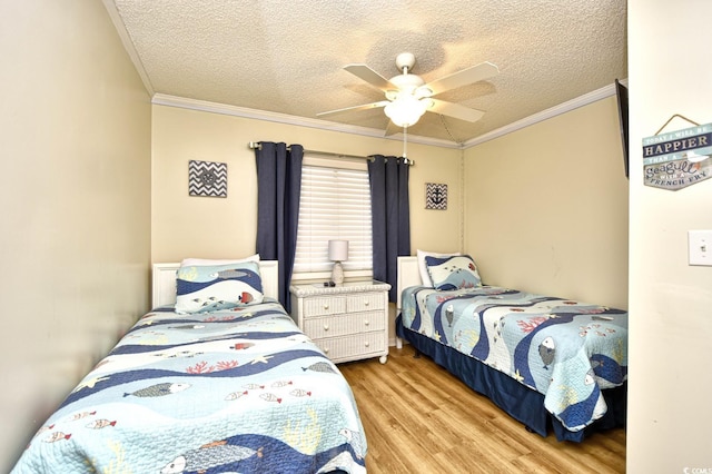 bedroom with crown molding, a textured ceiling, a ceiling fan, and wood finished floors
