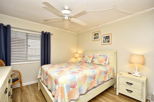 bedroom with crown molding, a textured ceiling, and wood finished floors
