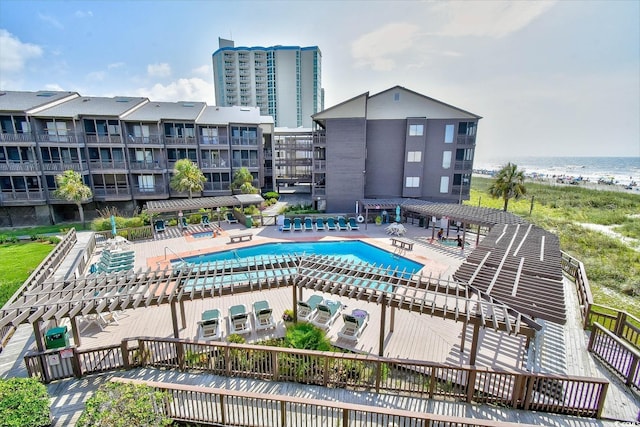 community pool with a water view and a patio