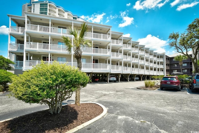view of building exterior with parking
