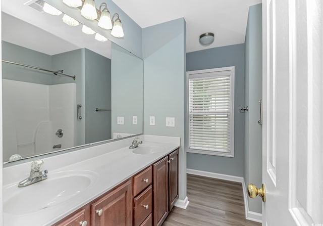 409 Hunley Ln, Myrtle Beach, SC 29577 - bathroom with double vanity, wood finished floors, and a shower