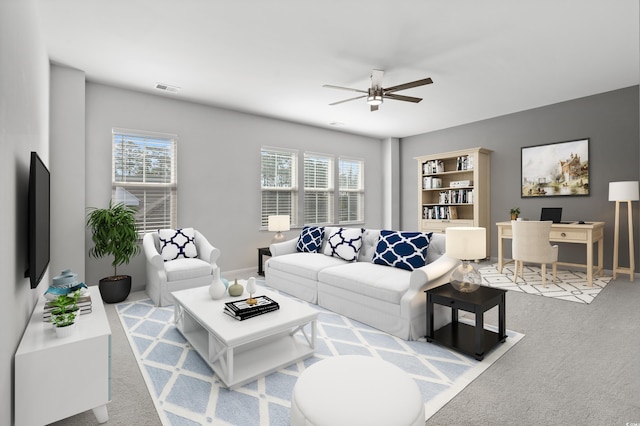 living room featuring baseboards, ceiling fan, carpet, and visible vents