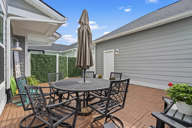 wooden terrace with outdoor dining area