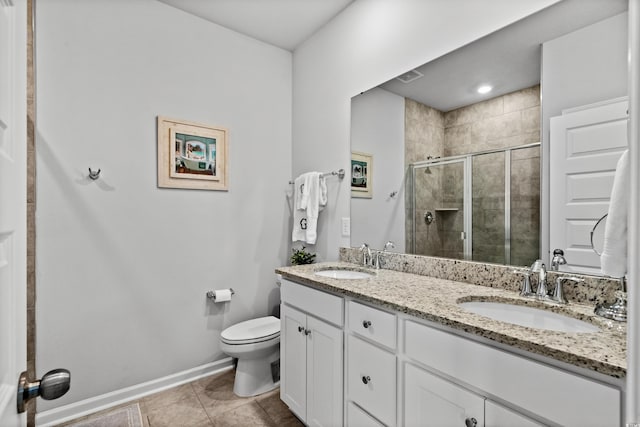 bathroom with toilet, baseboards, a sink, and a stall shower