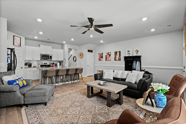 living area featuring a ceiling fan, visible vents, recessed lighting, and light wood-type flooring