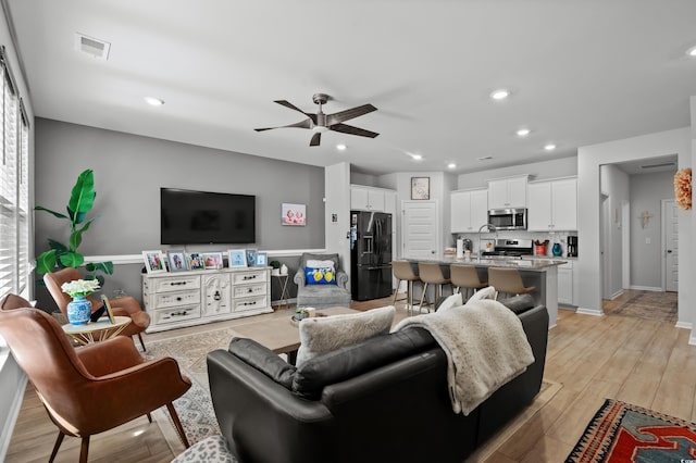 living area featuring a ceiling fan, recessed lighting, and visible vents