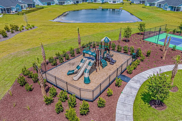 community play area with fence and a yard