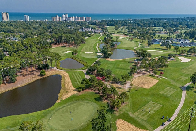 drone / aerial view with a water view and golf course view