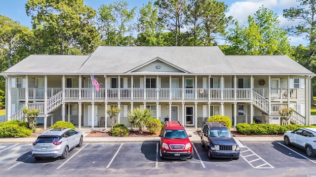 1260 White Tree Ln Unit F, Myrtle Beach, SC 29588 - view of building exterior with uncovered parking and stairway