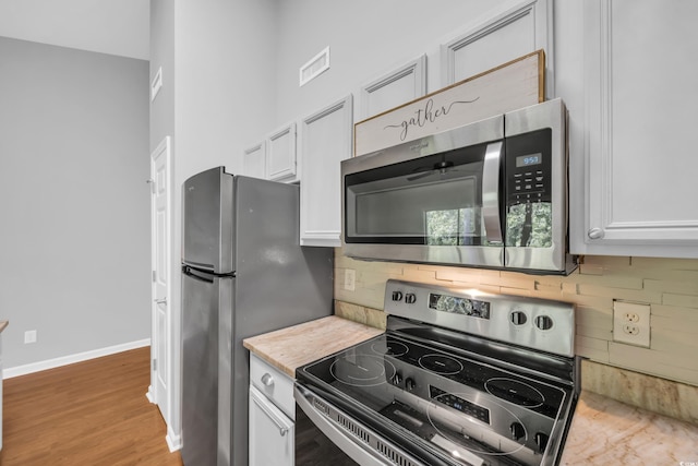 1260 White Tree Ln Unit F, Myrtle Beach, SC 29588 - kitchen featuring light countertops, tasteful backsplash, stainless steel appliances, and white cabinetry