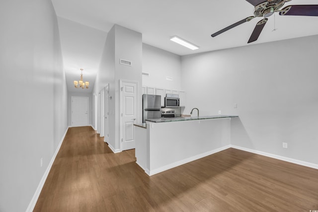 1260 White Tree Ln Unit F, Myrtle Beach, SC 29588 - kitchen with baseboards, dark wood-style flooring, a peninsula, and stainless steel appliances