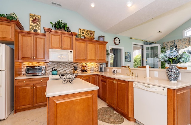 912 Berwick Ln, Myrtle Beach, SC 29579 - kitchen with white appliances, lofted ceiling, decorative backsplash, light countertops, and light tile patterned floors