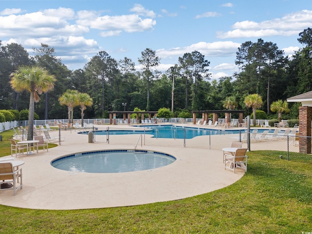 1097 Stoney Falls Blvd, Myrtle Beach, SC 29579 - community pool featuring a patio area and view of wooded area