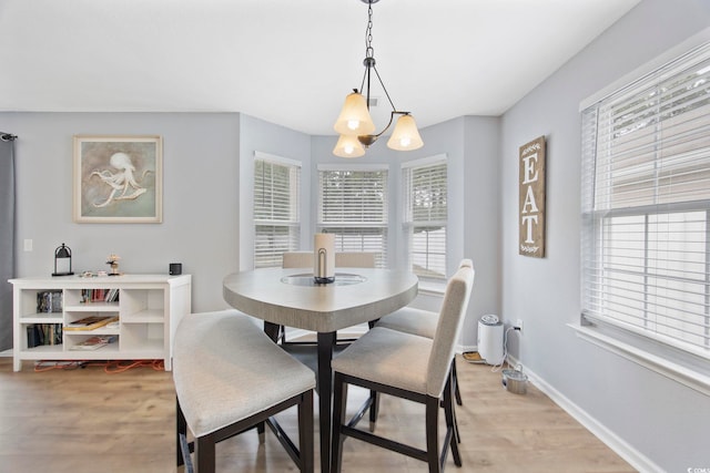 1097 Stoney Falls Blvd, Myrtle Beach, SC 29579 - dining area featuring light wood finished floors, baseboards, and a chandelier