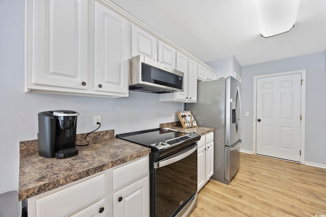 1097 Stoney Falls Blvd, Myrtle Beach, SC 29579 - kitchen featuring stainless steel appliances, white cabinets, light wood finished floors, dark countertops, and baseboards
