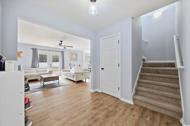 1097 Stoney Falls Blvd, Myrtle Beach, SC 29579 - living room with light wood-style floors, stairway, french doors, ceiling fan, and baseboards