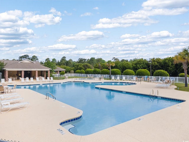 1097 Stoney Falls Blvd, Myrtle Beach, SC 29579 - community pool with a patio and view of scattered trees