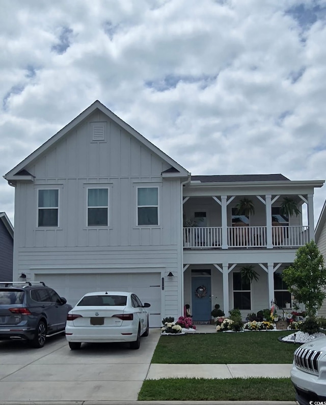 view of front facade with a balcony, a front yard, board and batten siding, concrete driveway, and an attached garage