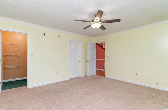 128 Causey St, Myrtle Beach, SC 29577 - unfurnished bedroom with light carpet, crown molding, a walk in closet, a closet, and a textured ceiling