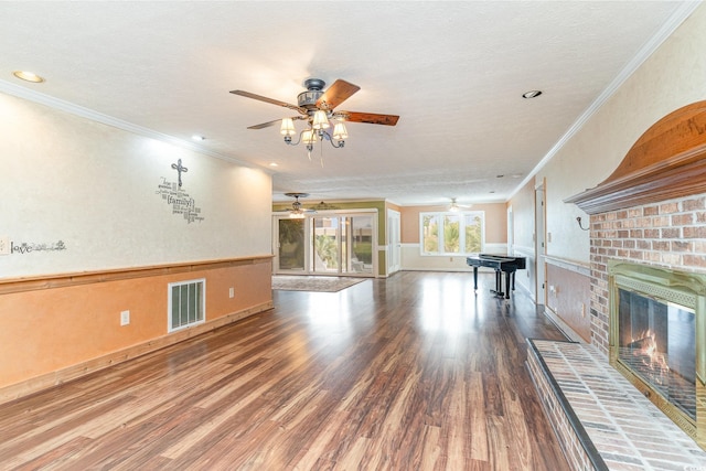 128 Causey St, Myrtle Beach, SC 29577 - unfurnished living room with ceiling fan, wood finished floors, a brick fireplace, ornamental molding, and a textured ceiling