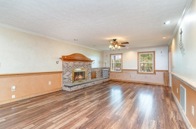 128 Causey St, Myrtle Beach, SC 29577 - unfurnished living room featuring a textured ceiling, wood finished floors, a fireplace, a ceiling fan, and ornamental molding