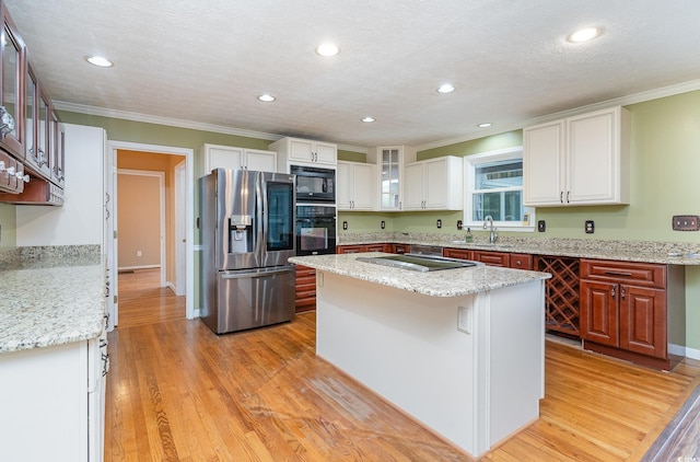 128 Causey St, Myrtle Beach, SC 29577 - kitchen with black appliances, crown molding, glass insert cabinets, a kitchen island, and recessed lighting