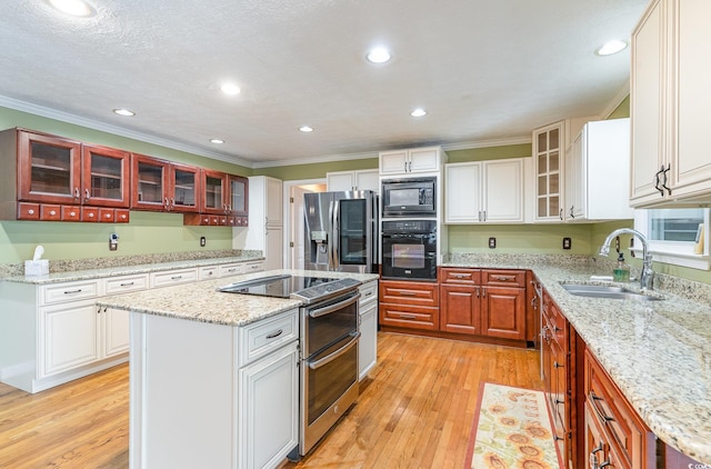 128 Causey St, Myrtle Beach, SC 29577 - kitchen with stainless steel appliances, a sink, crown molding, a center island, and light wood finished floors