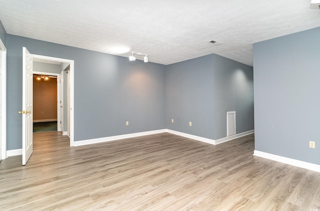 128 Causey St, Myrtle Beach, SC 29577 - spare room featuring wood finished floors, a textured ceiling, and baseboards