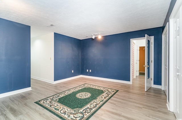 128 Causey St, Myrtle Beach, SC 29577 - empty room featuring wood finished floors, a textured ceiling, and baseboards