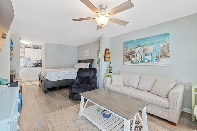 living room featuring light wood-type flooring and ceiling fan