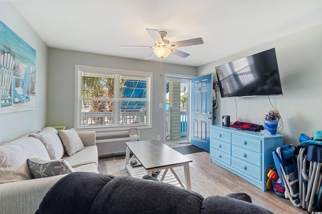 living room featuring wood finished floors, healthy amount of natural light, and a ceiling fan